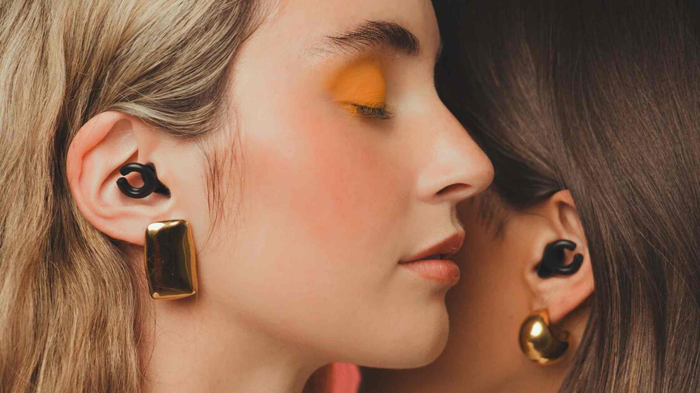 Ladies wearing HEAR Hush Hoops by Apothecary Products