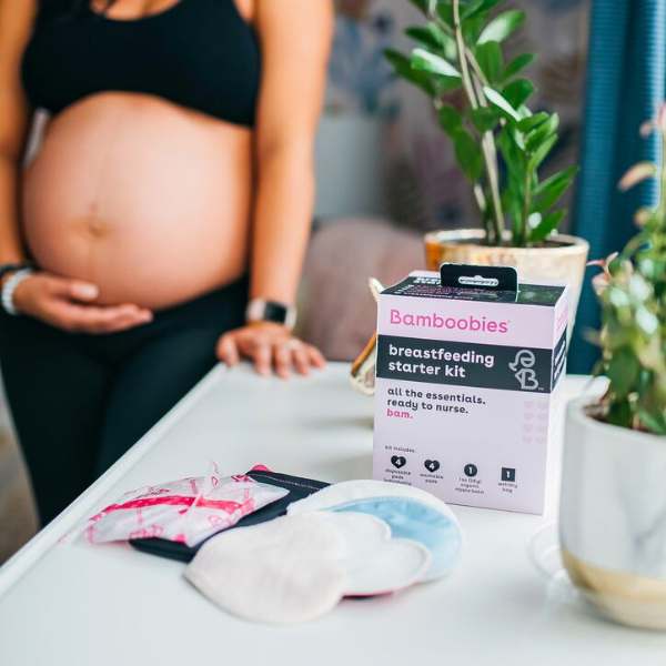 bamboobies breastfeeding starter kit next to pregnant woman