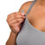 Woman up close wearing grey seamless nursing tank top showing nursing clip feature
