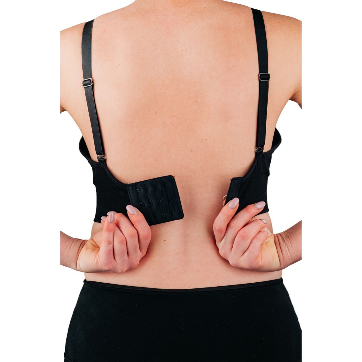 Back of woman wearing black bra with hook and loop closure